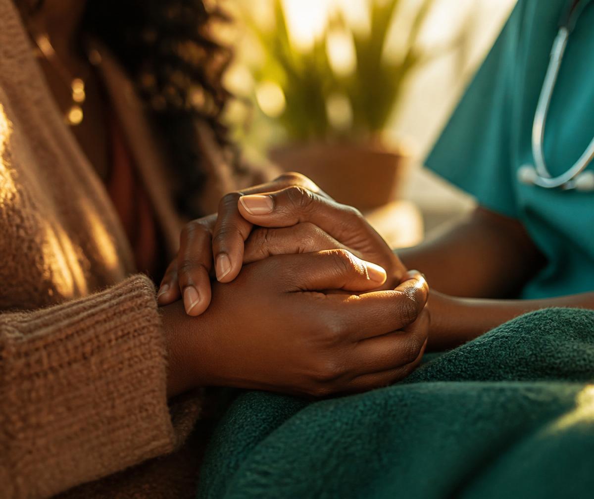 Two people holding hands in a gesture of support and comfort